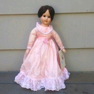 Antique porcelain doll with stand. Still has original tag - Anna's Dolls 1982.